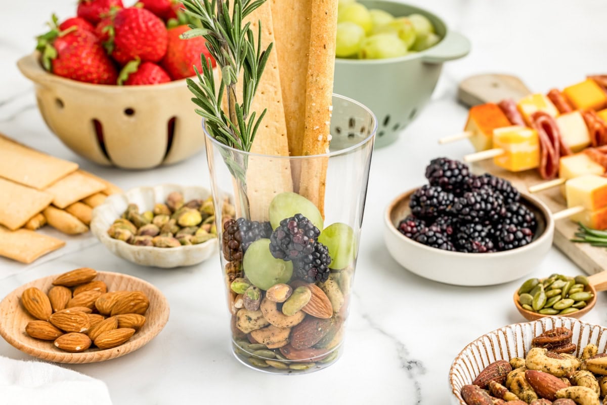 Breadsticks placed in to charcuterie cups.