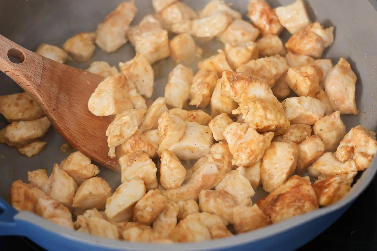 Creamy chicken stroganoff is perfect for dinner any night of the week. It's full of flavor and is made, start to finish, in about 30 minutes! Cooking chicken cubes in a skillet.