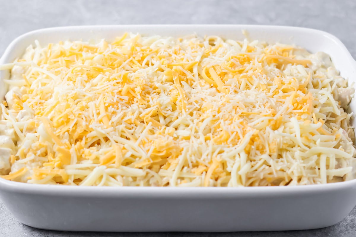 Shredded cheese on top of the unbaked tetrazzini.