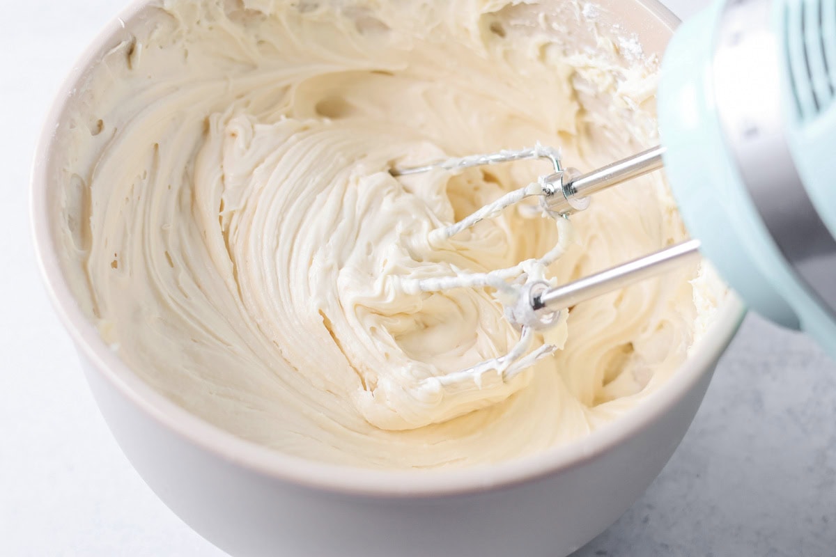Mixing the base of the chocolate chip dip in aa mixing bowl with an electric mixer.