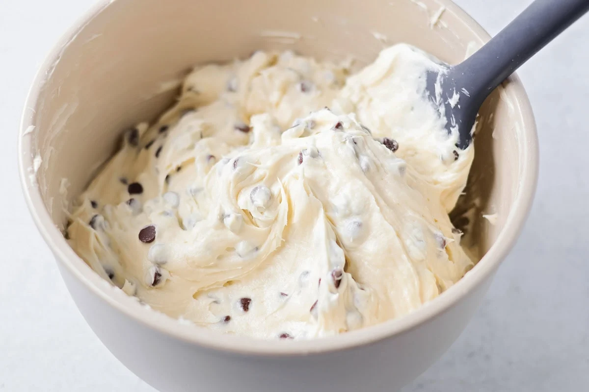 Fully mixed chocolate chip dip in a mixing bowl.