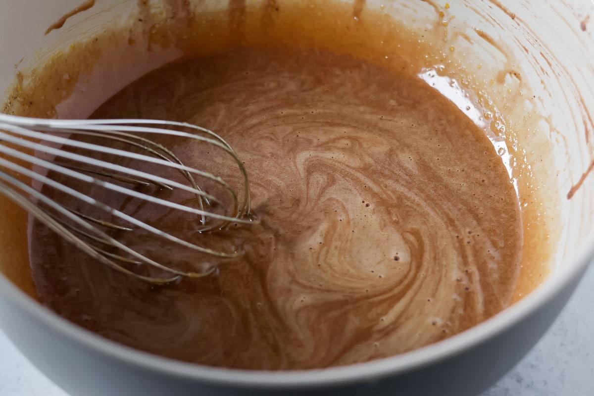 Mixing hot chocolate mixture into egg mixture.