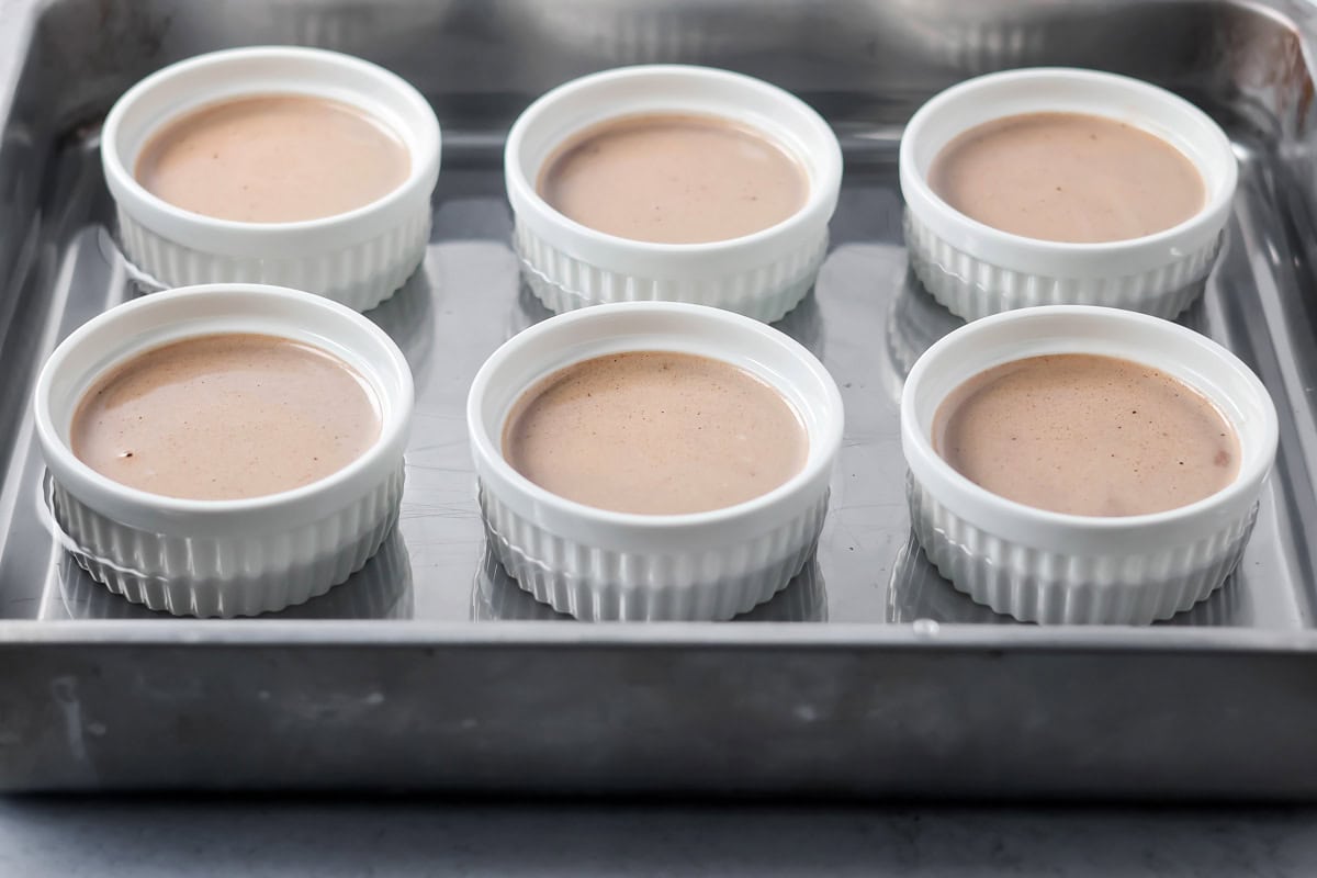 Chocolate custard in ramekins in water bath.