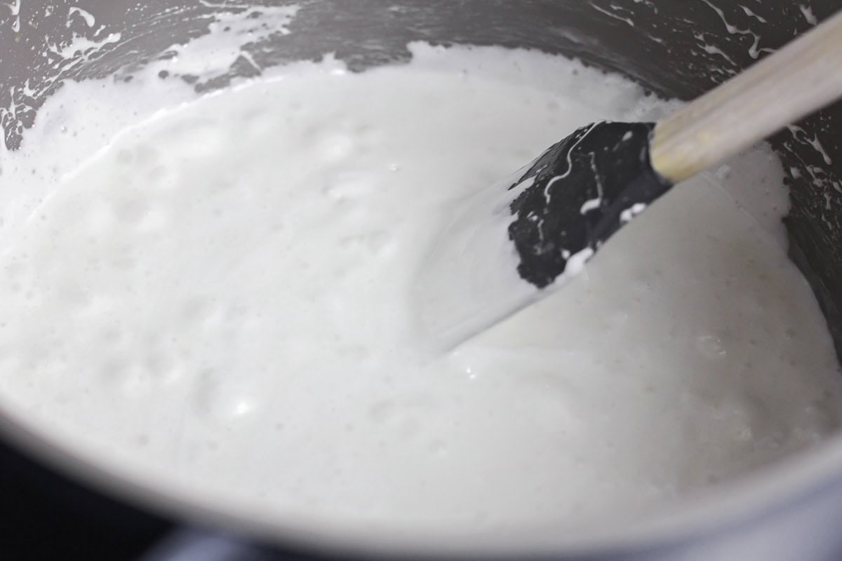 These no bake churro Rice Krispie treats showcase extra marshmallows and a cinnamon sugar topping for sweet, soft, and cozy bites. Melted marshmallows in a pot.