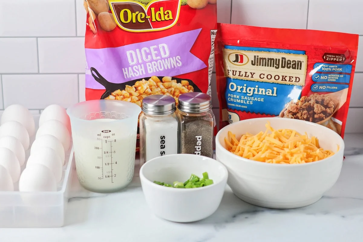 Crockpot breakfast casserole layers favorite breakfast foods for an easy and cozy dish that feeds a crowd with almost no effort. Ingredients to make a crockpot breakfast casserole on a kitchen counter.