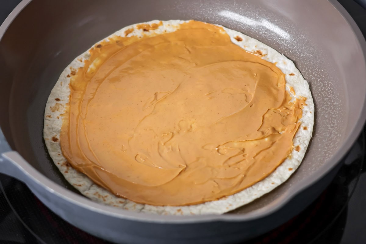 Cooking dessert quesadillas in skillet.