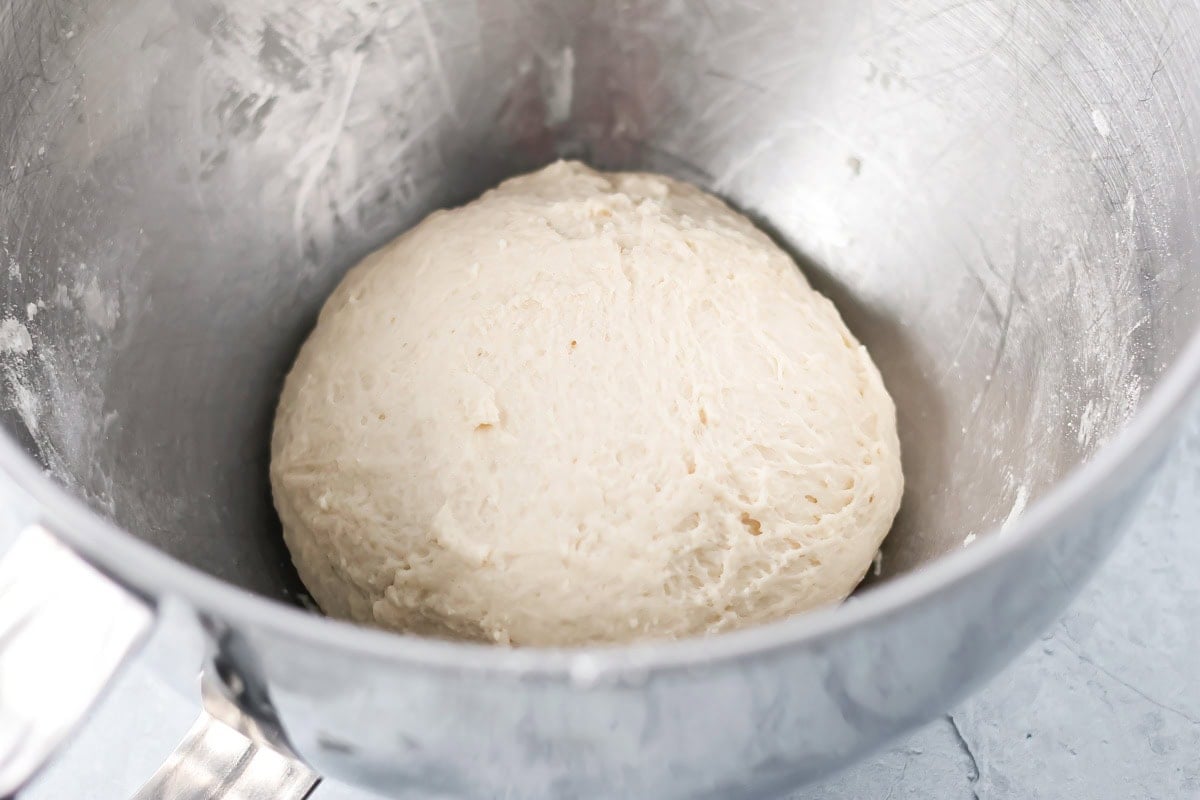 With just 4 ingredients, these easy yeast rolls are ready in under an hour and are perfect for a light snack or served with dinner. Mixed ball of dough in a mixing bowl.