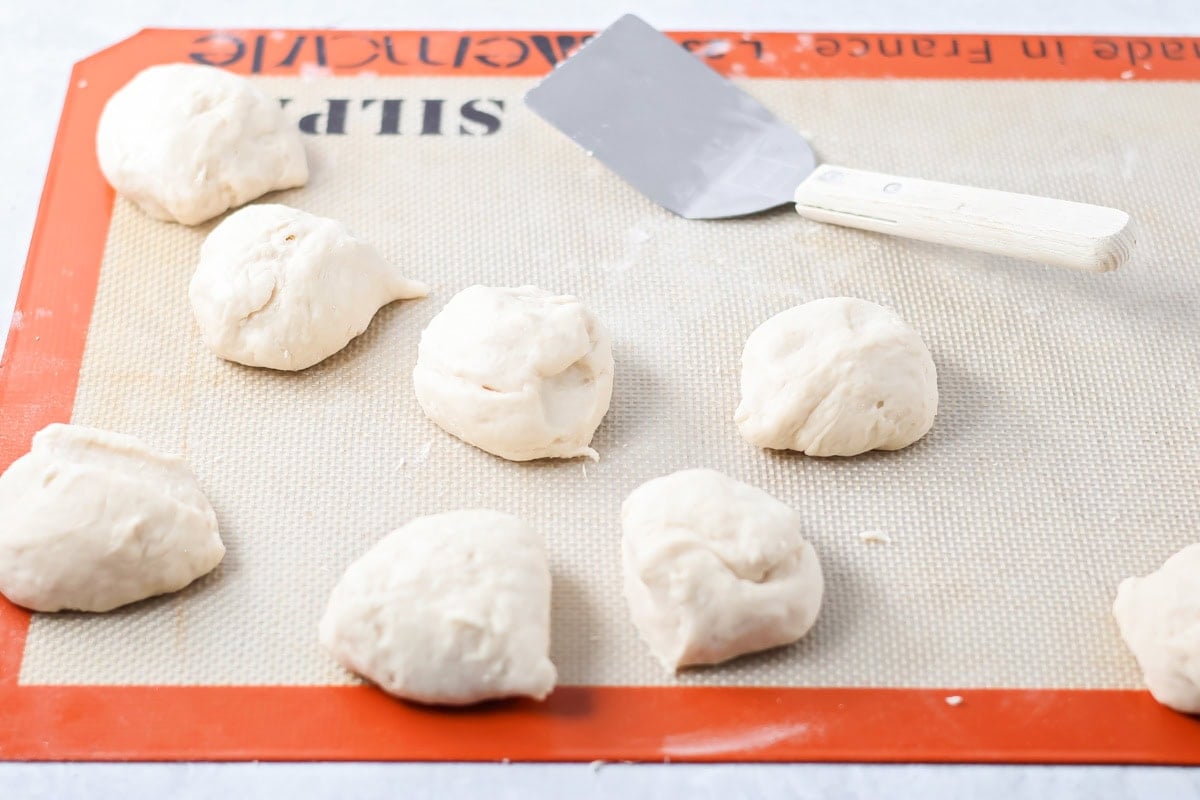 With just 4 ingredients, these easy yeast rolls are ready in under an hour and are perfect for a light snack or served with dinner. Cut pieces of dough on silicone mat.