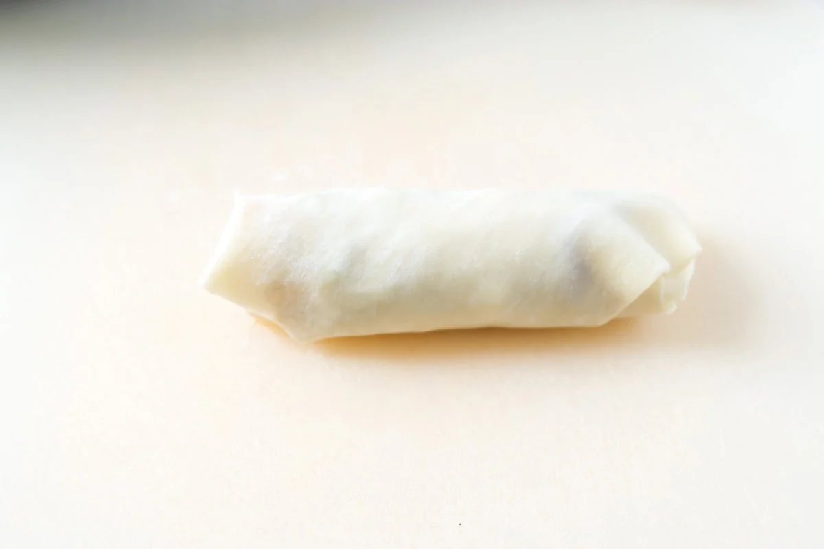 The top corner of the egg roll folded down.