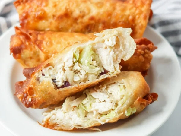 Homemade egg rolls served on a plate.