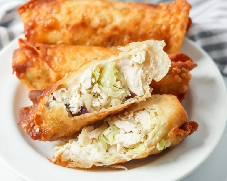Homemade egg rolls served on a plate.