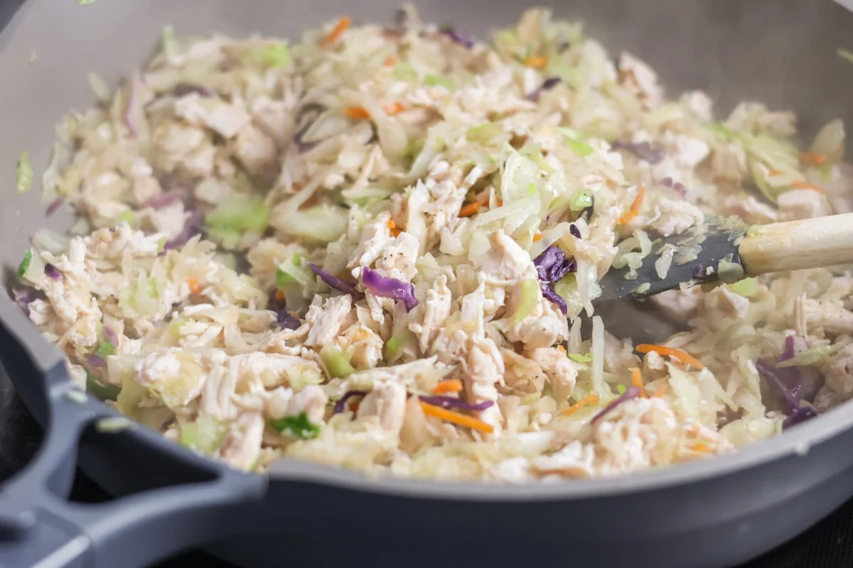 Cooked egg roll filling in a skillet.