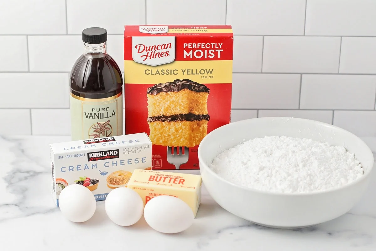 Ingredients for gooey butter cake on a white countertop.