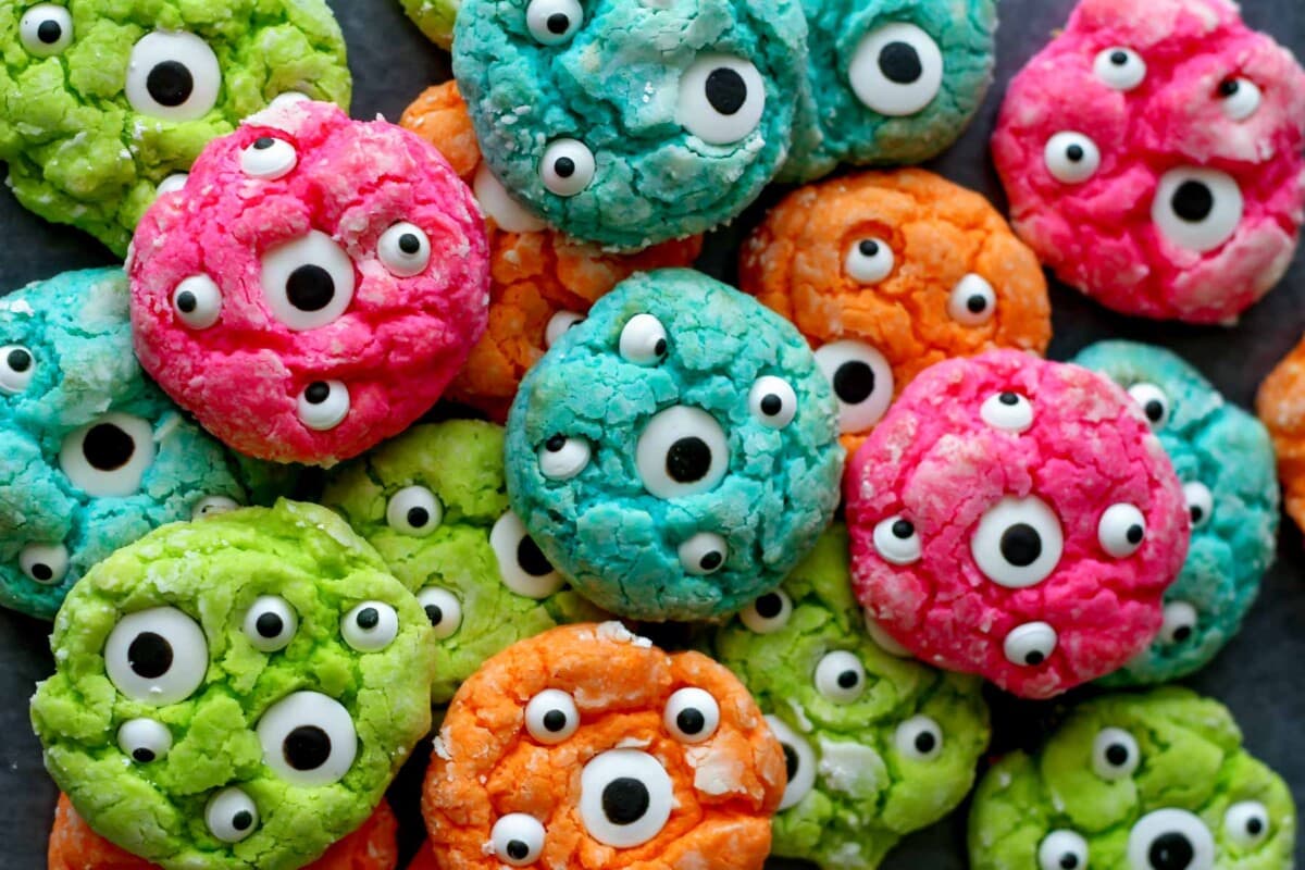 Gooey Monster Cookies stacked together on black counter.