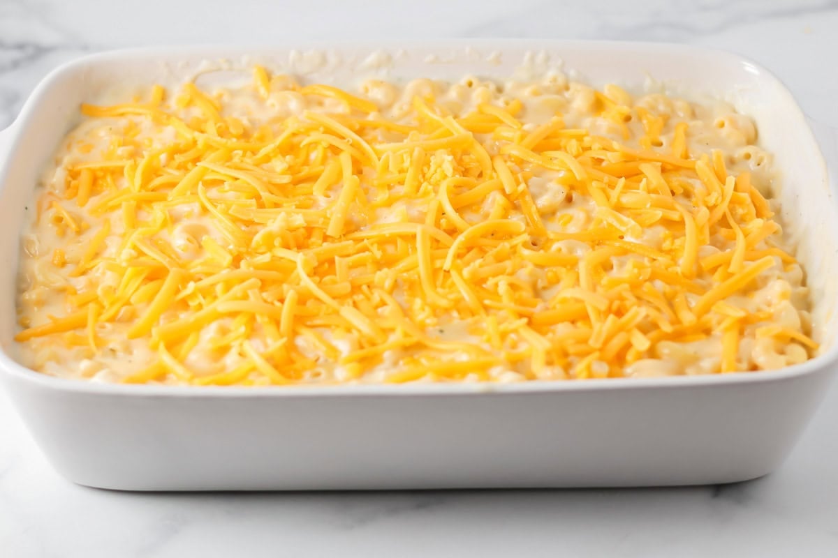 Shredded cheese poured on top of homemade mac and cheese.