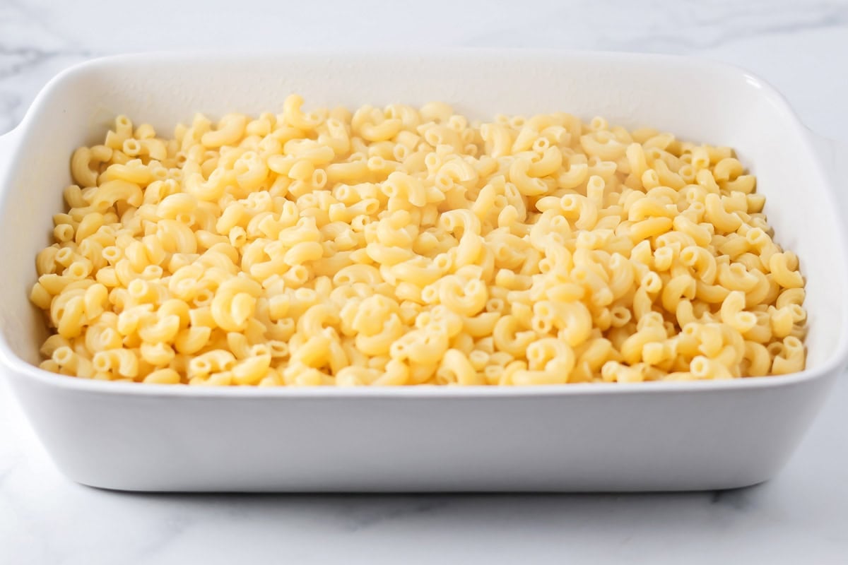 Mac and cheese recipe poured into casserole dish.