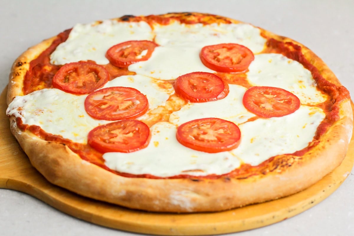 Margherita pizza stars fresh basil, mozzarella cheese, and the best ripe tomatoes. It's simple, delicious, and light. Baked Margherita pizza.