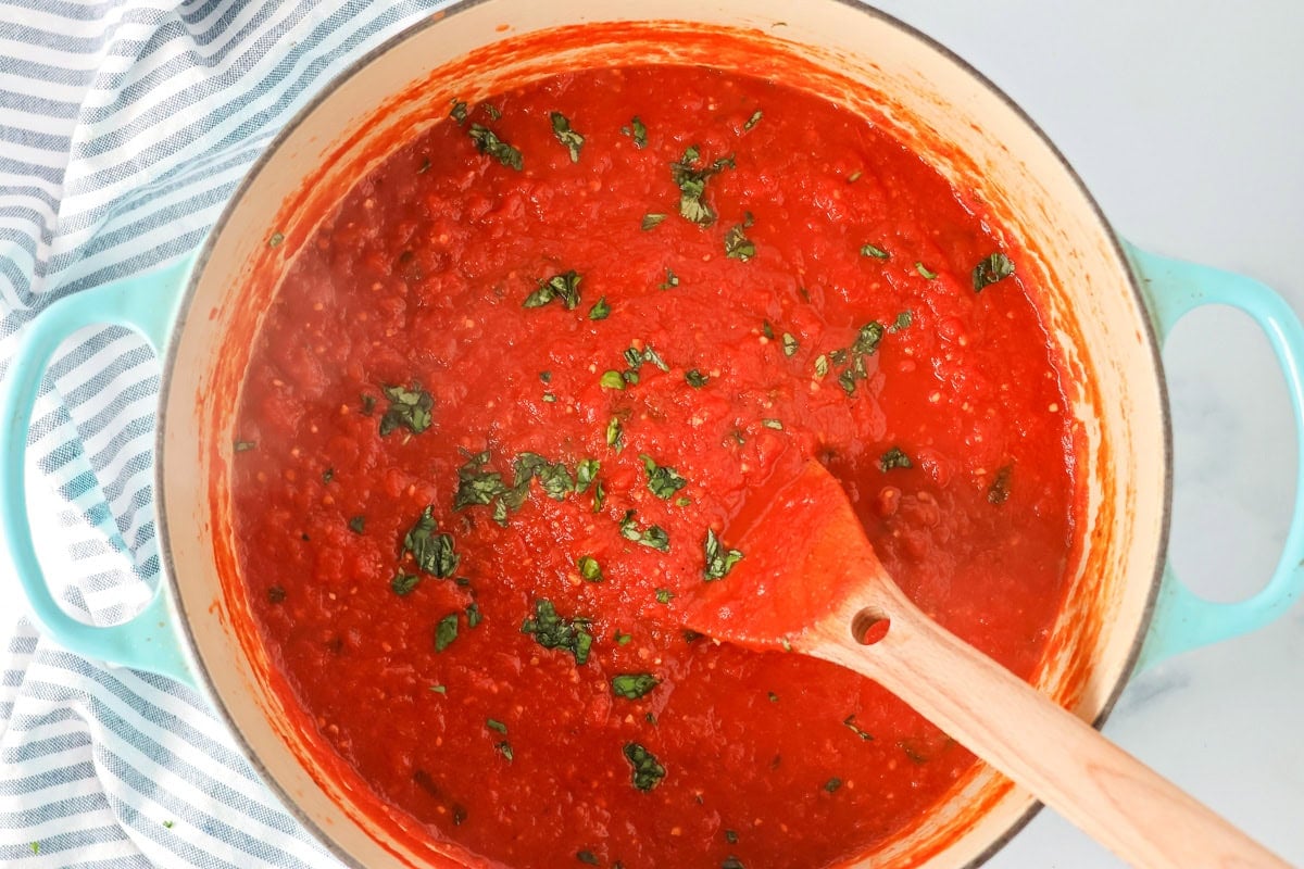 This simple homemade marinara sauce simmers fresh tomatoes with fragrant herbs and garlic for a versatile flavor explosion. Finished pot of marinara sauce.