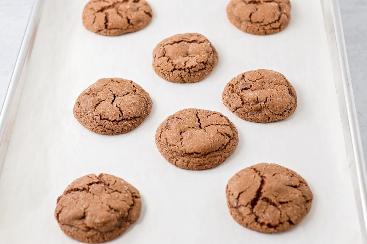 Easy Mexican hot chocolate cookies are soft and chocolatey with cinnamon sugar sparkle and a hint of heat, and perfect for sharing. Baked cookies on a baking sheet.