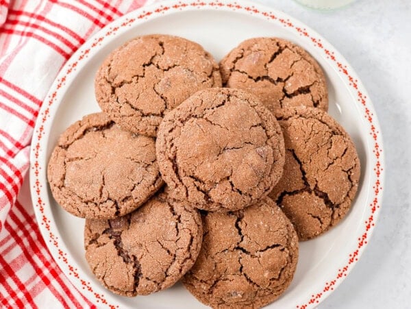 Mexican hot chocolate cookies piled on a white plate.