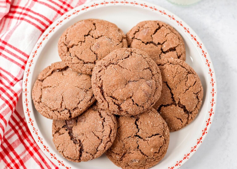 Mexican hot chocolate cookies piled on a white plate.