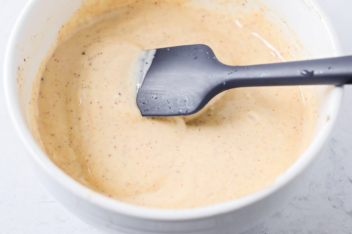 Creamy Mexican street corn pasta salad is a perfect balance of flavor, quick to toss together, and perfect for parties and easy dinners. Mixed pasta salad dressing in a bowl.