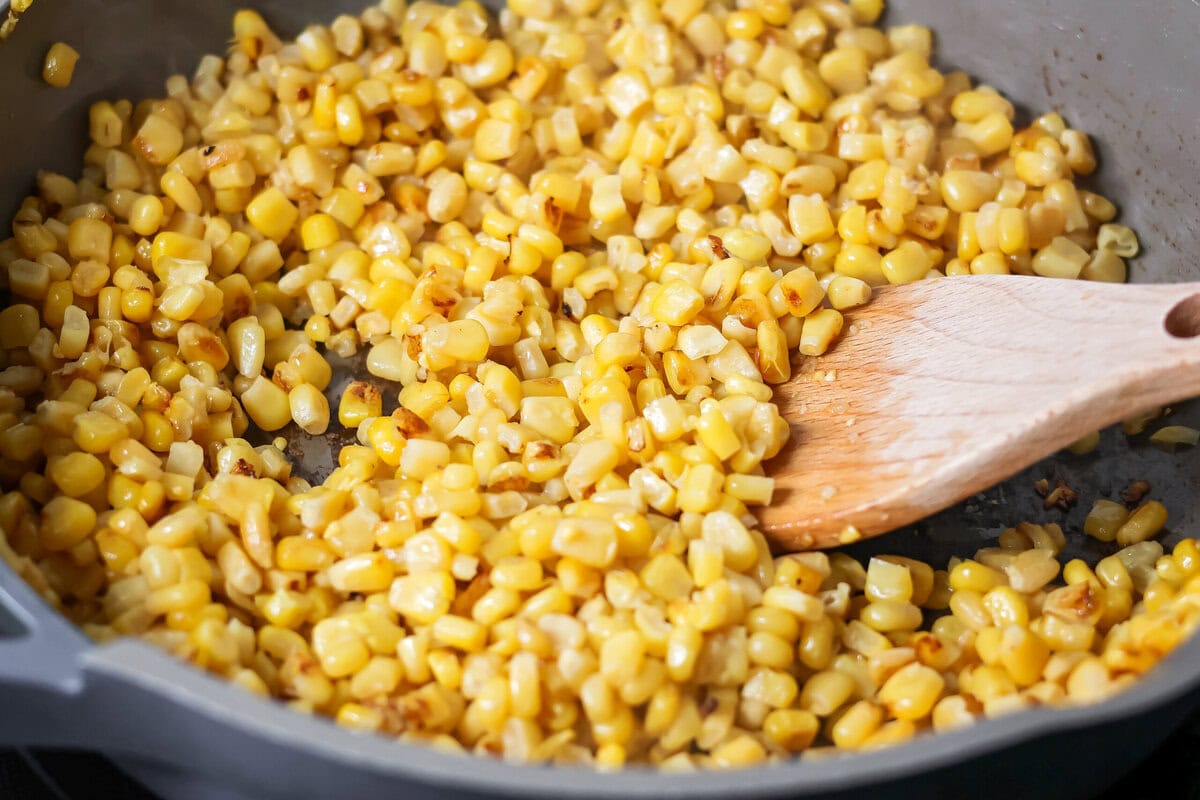 Creamy Mexican street corn pasta salad is a perfect balance of flavor, quick to toss together, and perfect for parties and easy dinners. Roasting corn kernels in a frying pan.