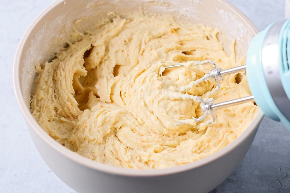 Soft orange brownies are made with simple ingredients, a quick bake, and a bright flavor that makes every slice feel special. Mixing orange brownie batter in a bowl.