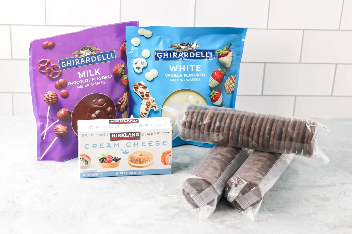 No-bake Oreo cream cheese balls are a three ingredient treat with a silky center and chocolate coating, ideal for every occasion. Ingredients to make Oreo truffle balls on a kitchen counter