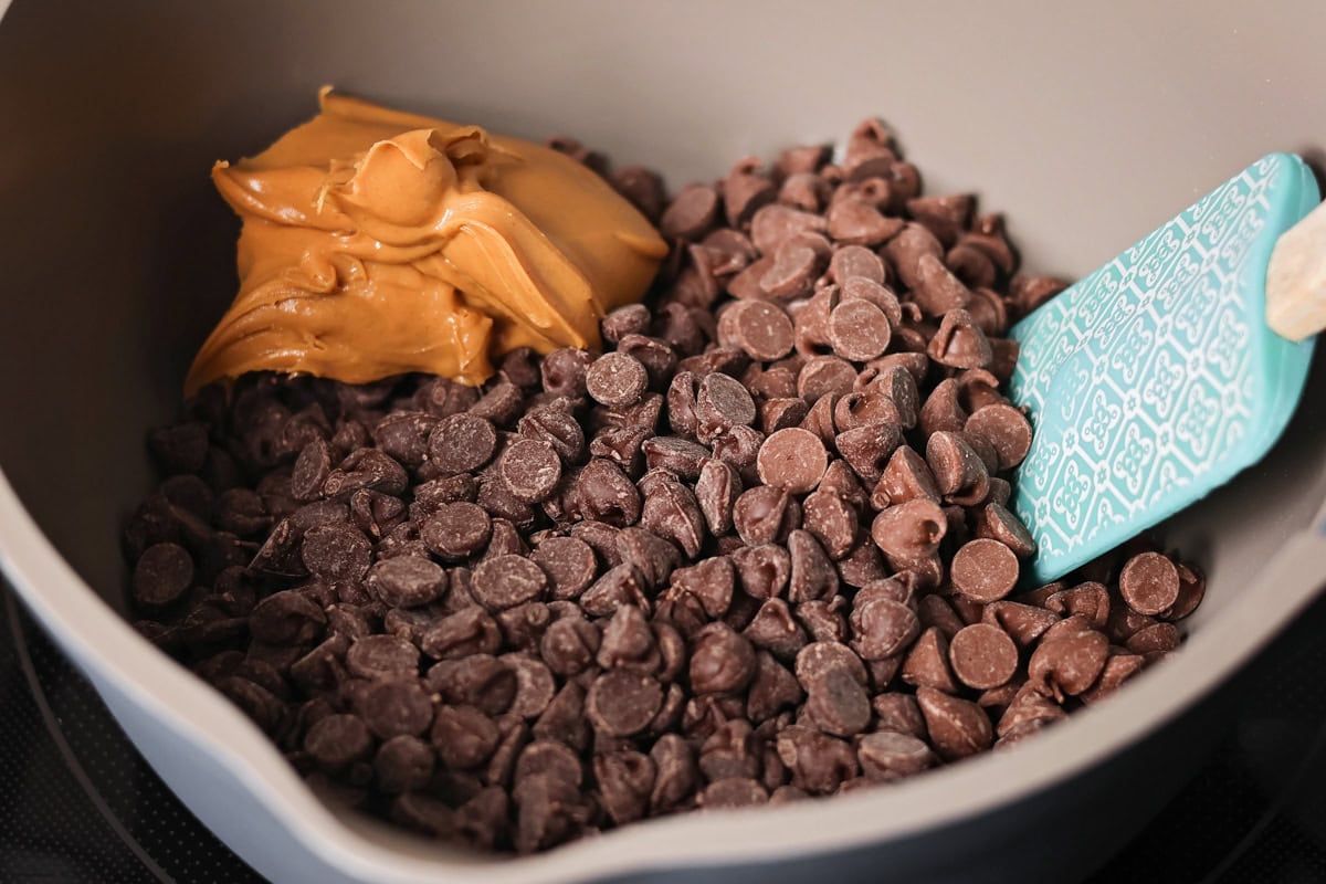Chocolate and peanut butter being cooked together in pot.