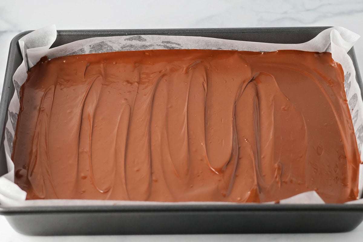 Chocolate topping poured over the top of peanut butter bars.