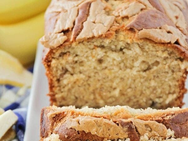 Peanut butter banana bread recipe cut into slices and placed on white plate.