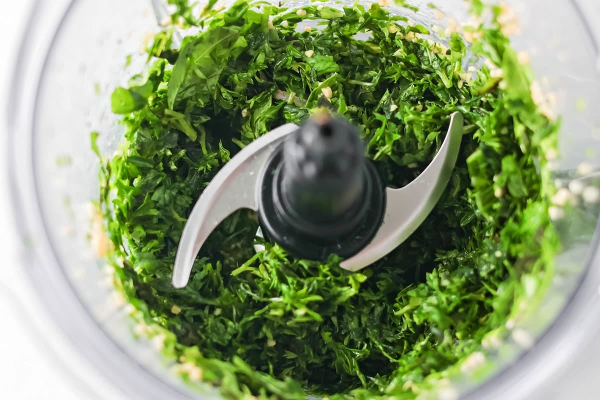 Fresh homemade basil pesto is easy and quick to make. From pasta to sandwiches, it will be a family favorite you use all week! Pine nuts added to the slightly processed herbs.