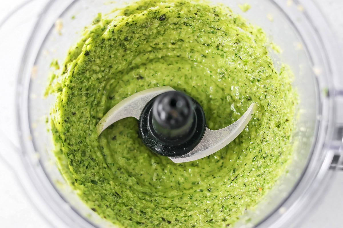 Fresh homemade basil pesto is easy and quick to make. From pasta to sandwiches, it will be a family favorite you use all week! Fully processed basil pesto in a food processor.