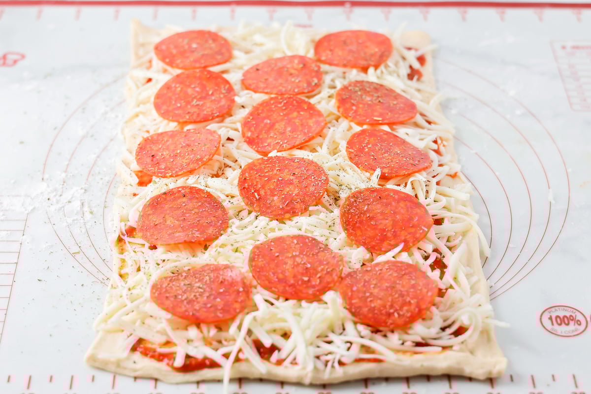 Sauce, cheese and pepperoni sprinkled over crescent dough.