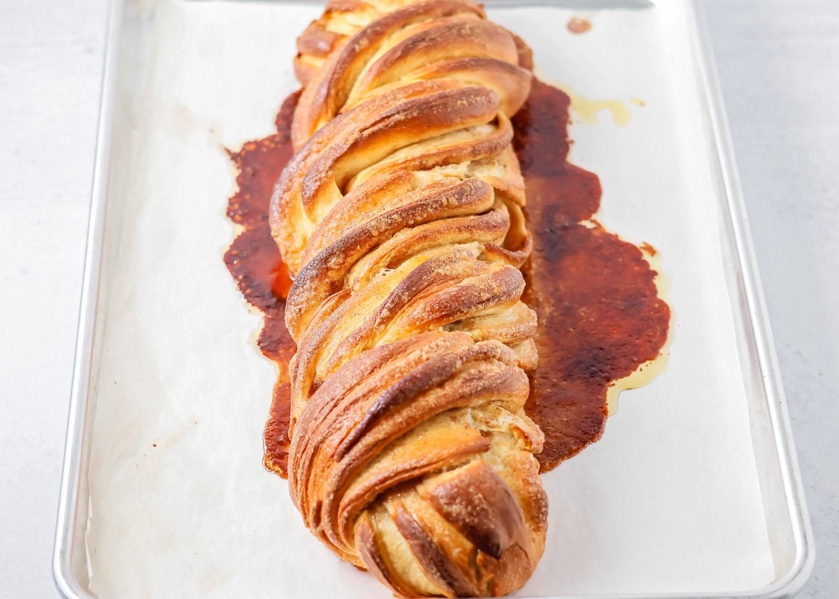 Quick cinnamon twists are made with a simple soft, buttery dough, and swirled with cinnamon sugar and are perfect for breakfast or dessert. Baked cinnamon twist on a baking sheet.