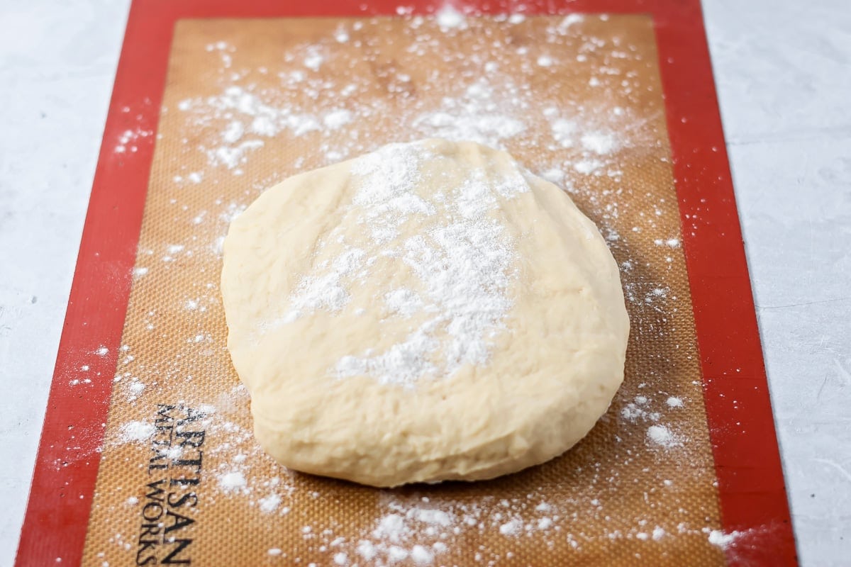 Quick cinnamon twists are made with a simple soft, buttery dough, and swirled with cinnamon sugar and are perfect for breakfast or dessert. Flour sprinkled on a ball of dough.