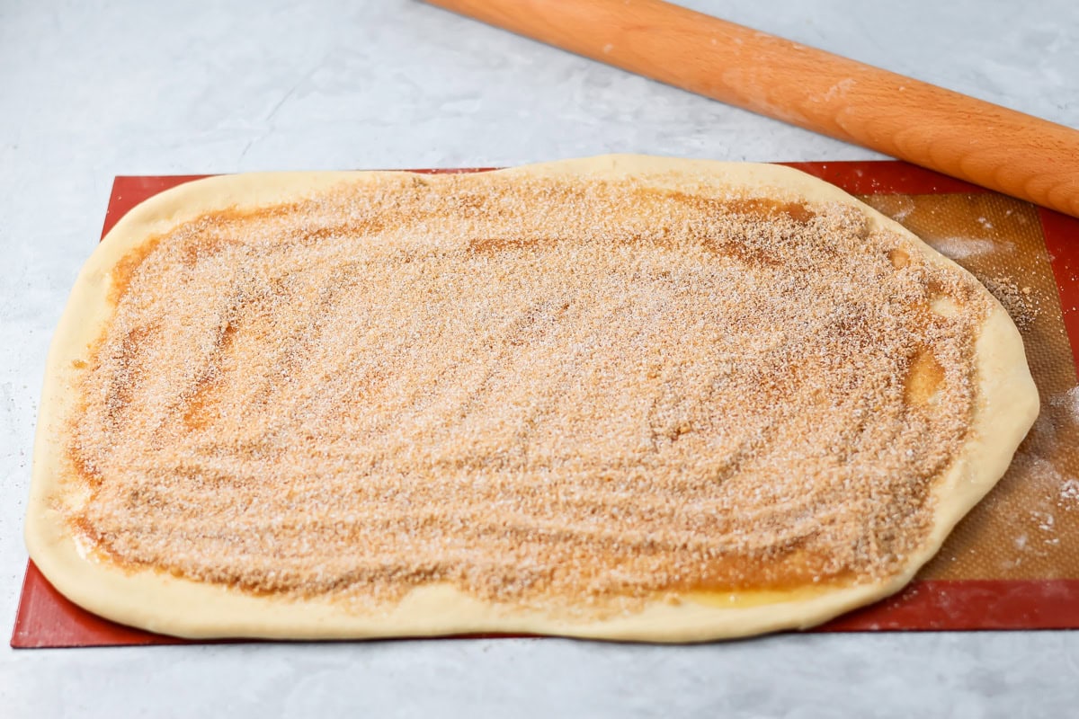 Quick cinnamon twists are made with a simple soft, buttery dough, and swirled with cinnamon sugar and are perfect for breakfast or dessert. Cinnamon sugar spread over rolled out dough.