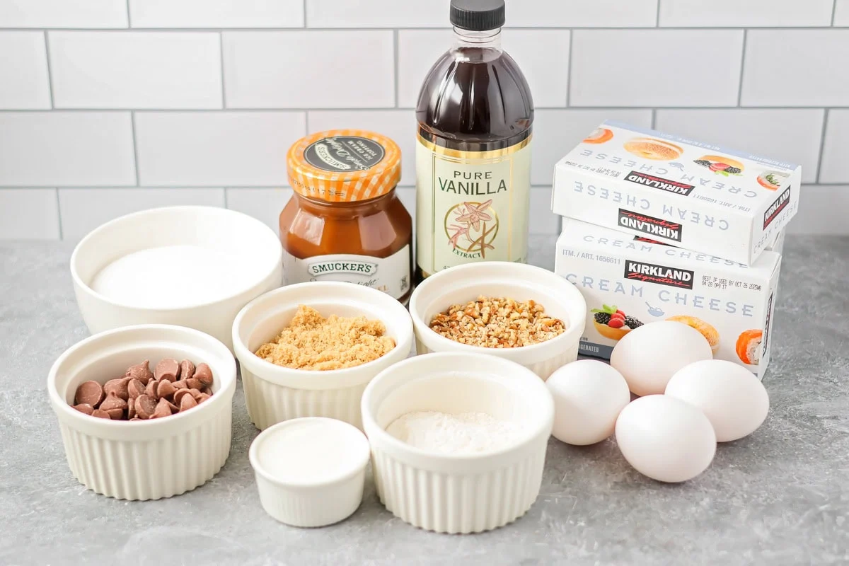 Ingredients to make a turtle topping for a cheesecake on a kitchen counter.