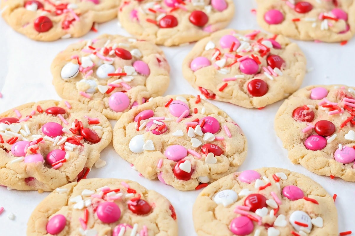 Valentine cookies are soft and chewy with chocolate pops of pink, red, and white M&M's. They are Valentine's perfection! Baked Valentines Day Cookies on a tray.