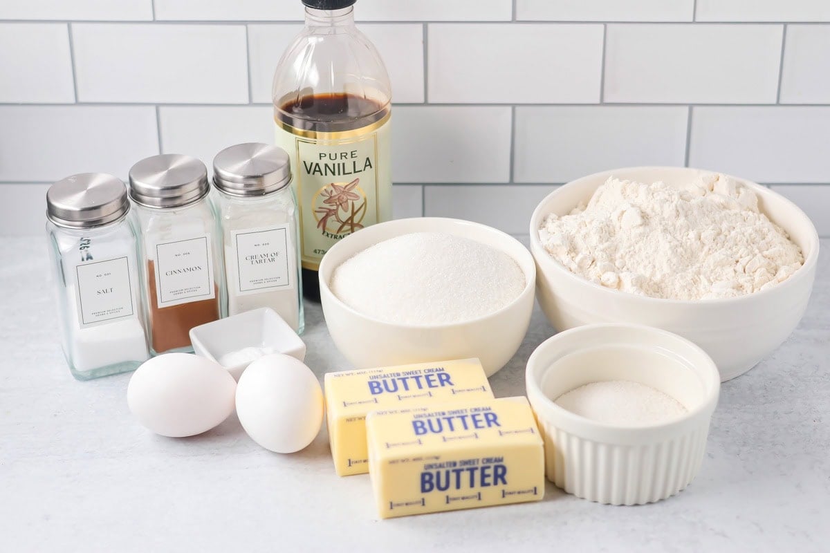 Family favorite brown butter snickerdoodle recipe is easy to make with a soft center, classic tang, and cozy flavor. Cookie ingredients on a kitchen counter.