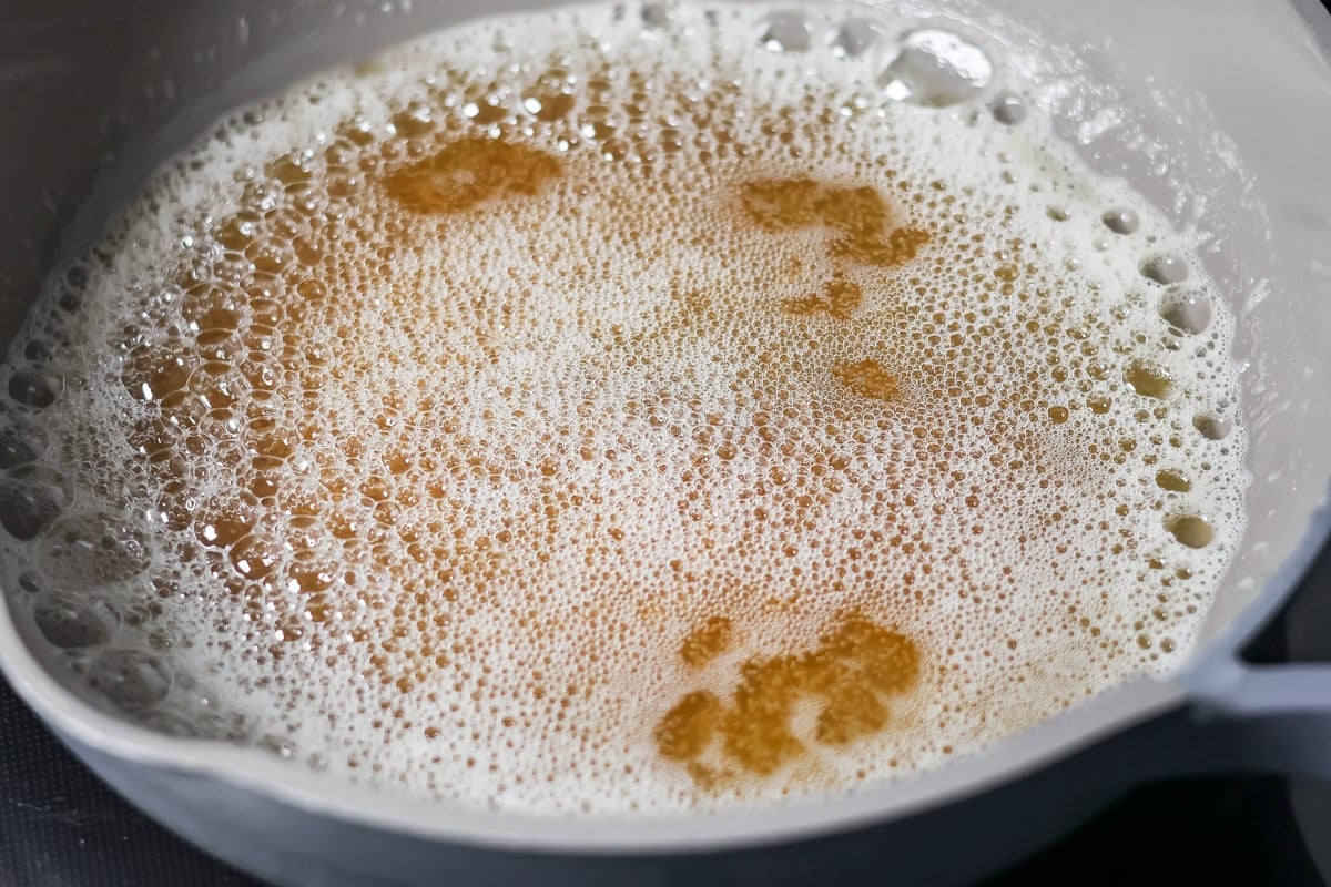 Family favorite brown butter snickerdoodle recipe is easy to make with a soft center, classic tang, and cozy flavor. Browned butter in a pan.