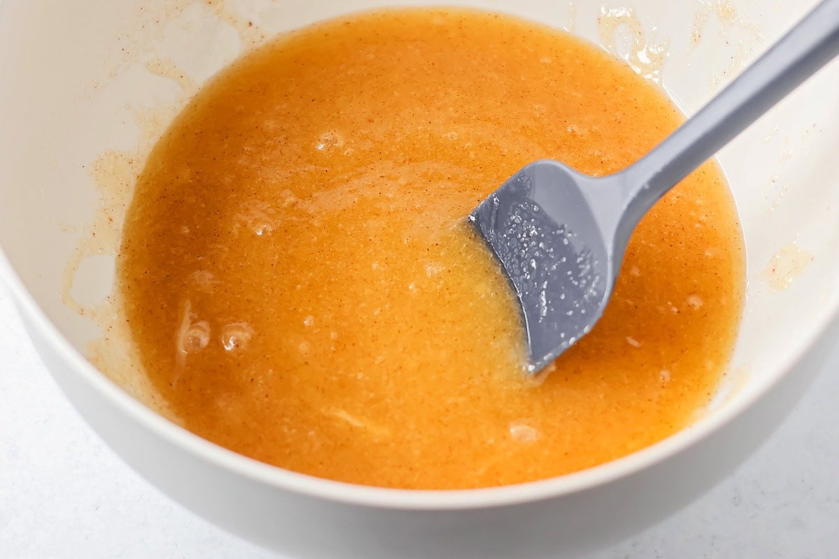 Family favorite brown butter snickerdoodle recipe is easy to make with a soft center, classic tang, and cozy flavor. Browned butter poured in a mixing bowl.