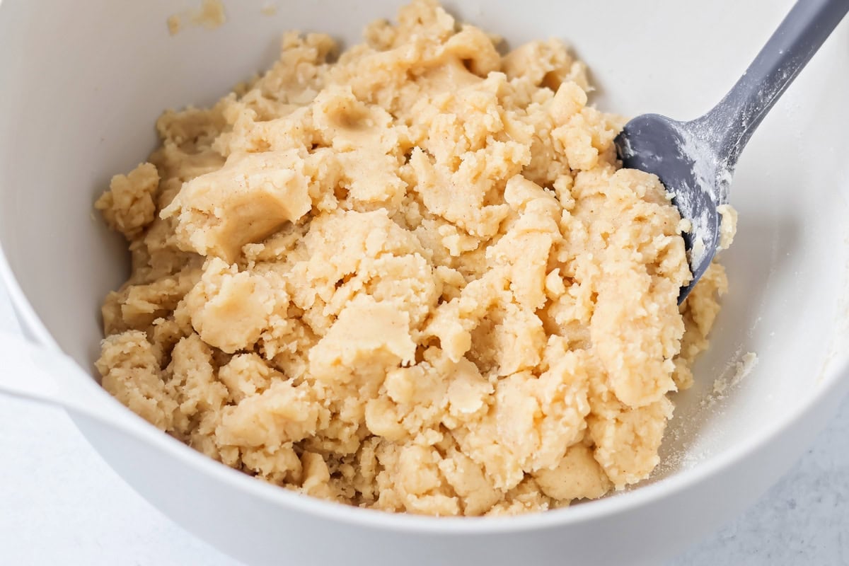 Family favorite brown butter snickerdoodle recipe is easy to make with a soft center, classic tang, and cozy flavor. Cookie dough in a mixing bowl.