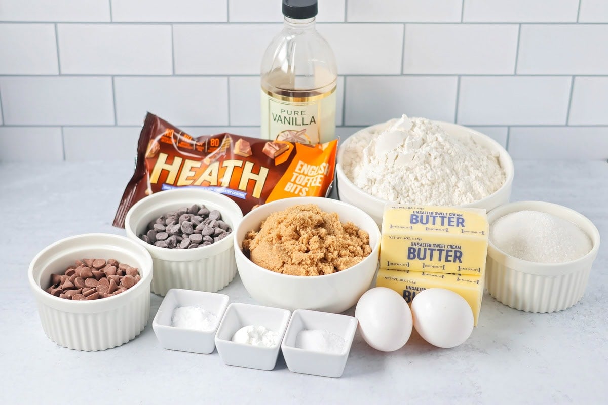 Browned butter toffee chocolate chip cookies with chewy centers and melty chips is an easy bakery-style cookie the whole family loves. Ingredients to make cookies on a kitchen counter.