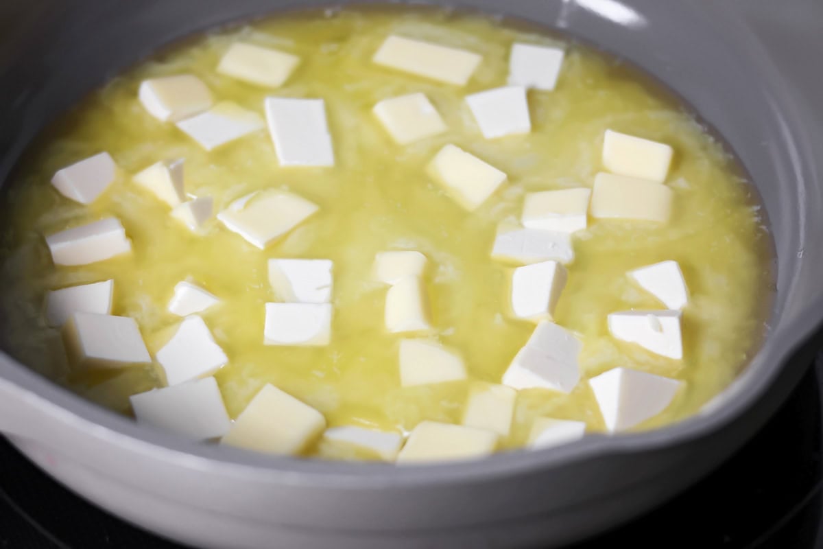Browned butter toffee chocolate chip cookies with chewy centers and melty chips is an easy bakery-style cookie the whole family loves. Melting pats of butter in a pan.