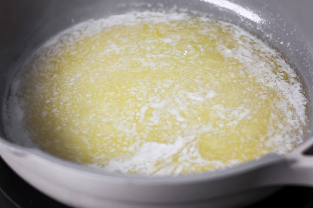 Browned butter toffee chocolate chip cookies with chewy centers and melty chips is an easy bakery-style cookie the whole family loves. Melted butter in a pan.