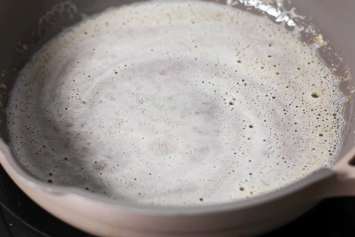 Browned butter toffee chocolate chip cookies with chewy centers and melty chips is an easy bakery-style cookie the whole family loves. Browned butter in a pan.
