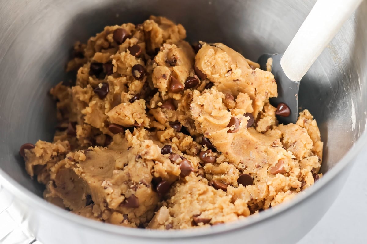 Browned butter toffee chocolate chip cookies with chewy centers and melty chips is an easy bakery-style cookie the whole family loves. Fully mixed cookie dough in a mixing bowl.
