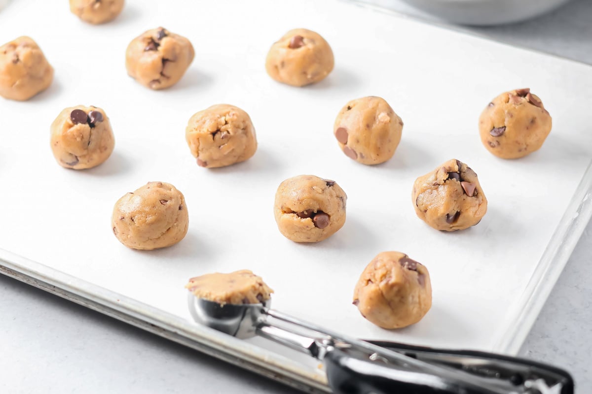 Browned butter toffee chocolate chip cookies with chewy centers and melty chips is an easy bakery-style cookie the whole family loves. Scooping dough balls onto a baking sheet,